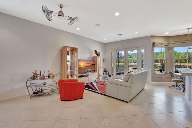 living room featuring plenty of natural light, recessed lighting, baseboards, and light tile patterned flooring
