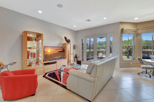living room with recessed lighting, tile patterned floors, french doors, and baseboards