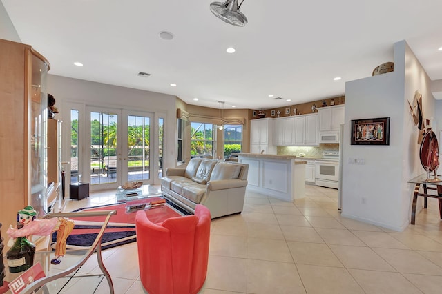 living room featuring light tile patterned flooring, recessed lighting, and french doors