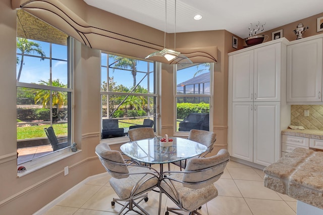 dining area with light tile patterned floors, healthy amount of natural light, and recessed lighting