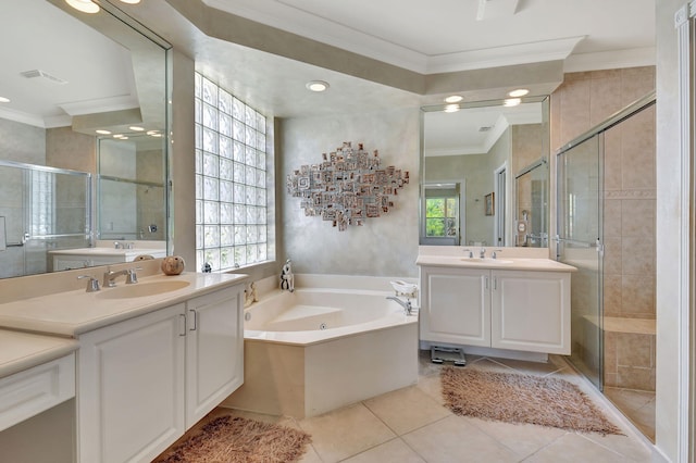 bathroom featuring ornamental molding, a stall shower, tile patterned floors, a bath, and two vanities