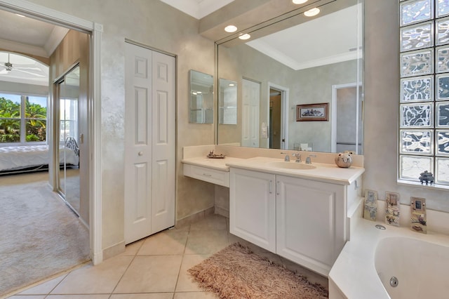 ensuite bathroom featuring crown molding, healthy amount of natural light, tile patterned flooring, and vanity