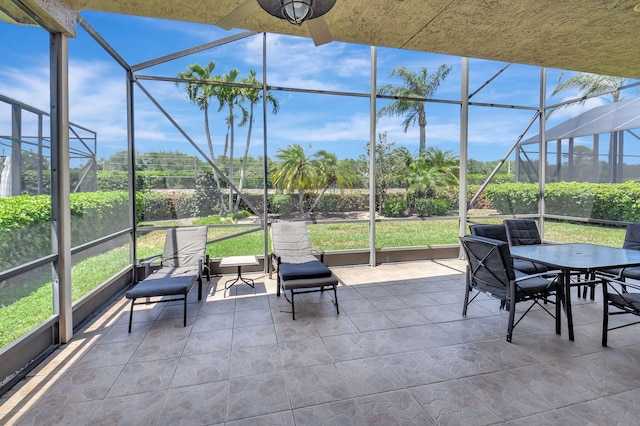 view of patio featuring a lanai and outdoor dining area
