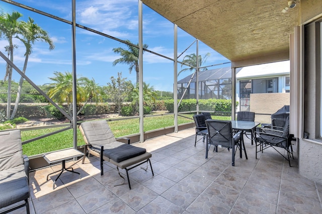sunroom / solarium featuring outdoor dining space and healthy amount of natural light