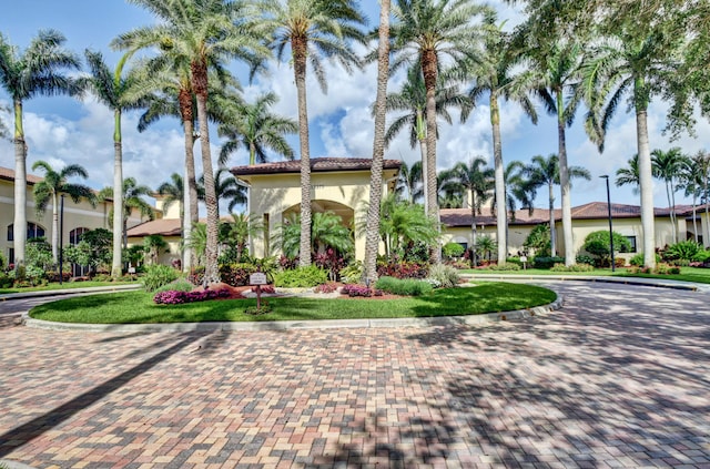 view of building exterior with curved driveway