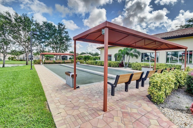 view of property's community with a game area and a yard