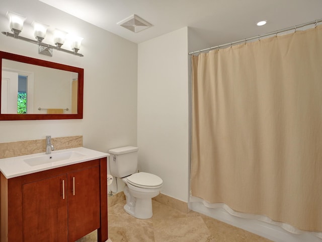 full bathroom featuring toilet, vanity, and tile patterned flooring