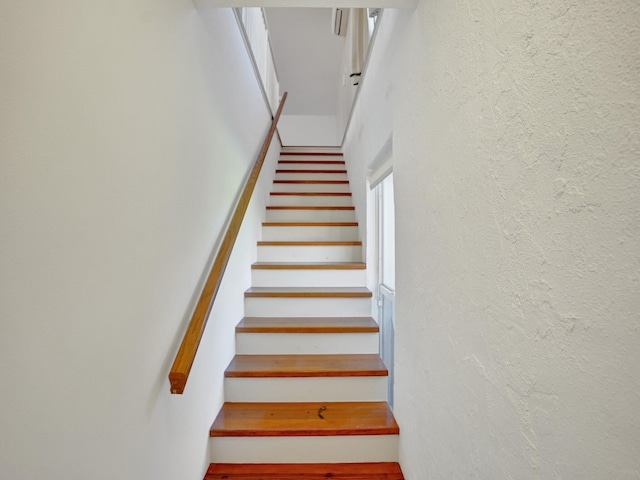 staircase with a textured wall