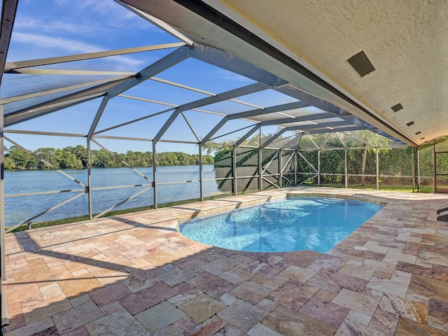swimming pool featuring a patio area, a water view, glass enclosure, and a dock