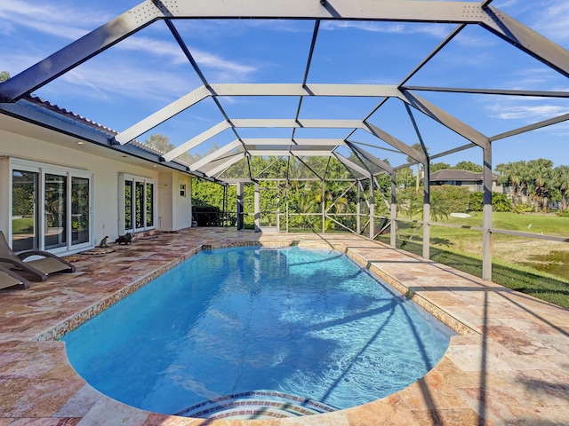 swimming pool featuring a patio area, a yard, and a lanai
