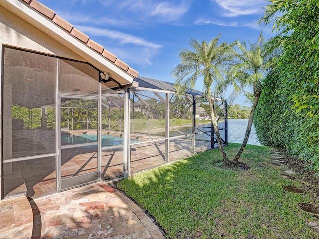 view of grassy yard with an outdoor pool, a patio, a water view, and a lanai
