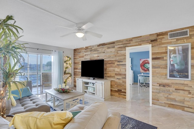 2724 N Garden Dr Unit 302, Lake Worth, FL 33461 - living room with wood walls, a ceiling fan, and light marble finish floors