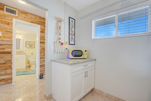 2724 N Garden Dr Unit 302, Lake Worth, FL 33461 - hallway with light marble finish flooring and wood walls