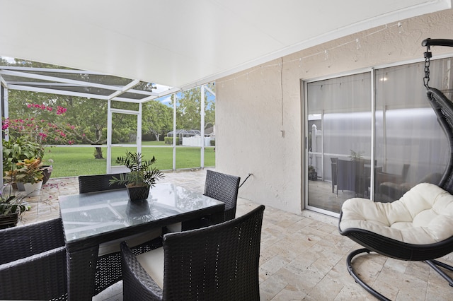 sunroom featuring outdoor dining area