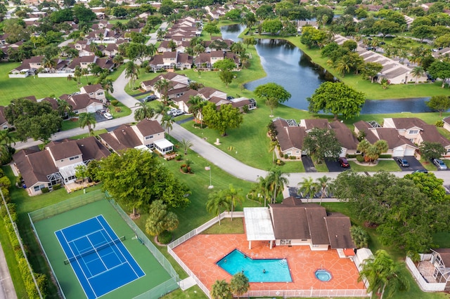 aerial view of residential area with a nearby body of water and a pool area
