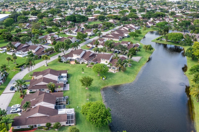 aerial view of property and surrounding area with a nearby body of water and nearby suburban area