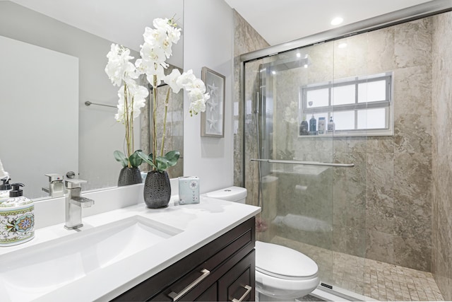 full bath featuring toilet, a shower stall, and vanity