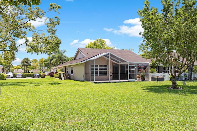 rear view of house with a lawn and stucco siding
