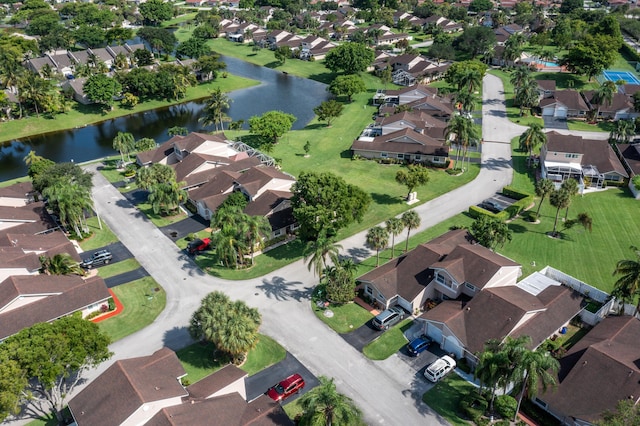aerial view of property's location featuring a large body of water and nearby suburban area