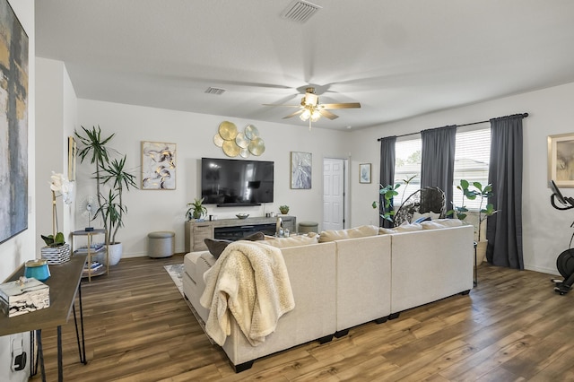 living room featuring a ceiling fan, wood finished floors, and baseboards