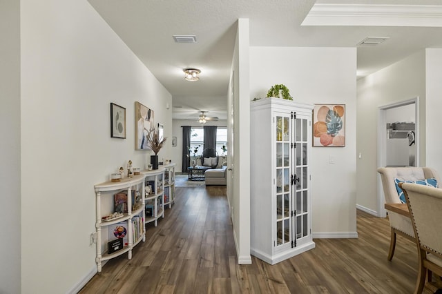 hall featuring wood finished floors and baseboards