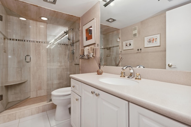 full bath with a stall shower, vanity, toilet, and tile patterned flooring