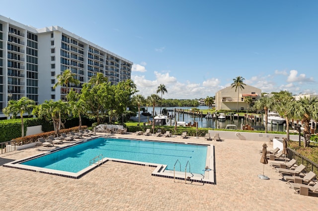 community pool with a patio and a water view