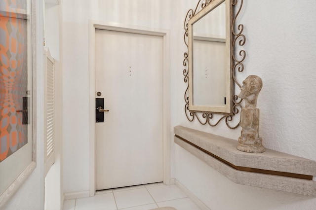 entryway featuring light tile patterned floors and baseboards