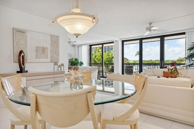 dining room featuring ceiling fan, floor to ceiling windows, and tile patterned floors