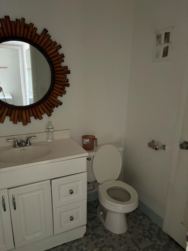 bathroom with vanity, toilet, and tile patterned flooring