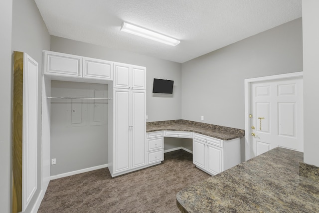 4841 Glenn Pine Ln, Boynton Beach, FL 33436 - unfurnished office featuring built in study area, dark carpet, a textured ceiling, and baseboards