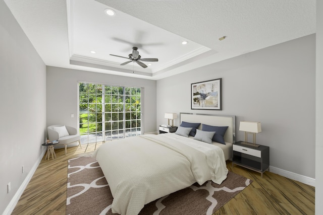 4841 Glenn Pine Ln, Boynton Beach, FL 33436 - bedroom featuring a raised ceiling, wood finished floors, baseboards, access to exterior, and a ceiling fan