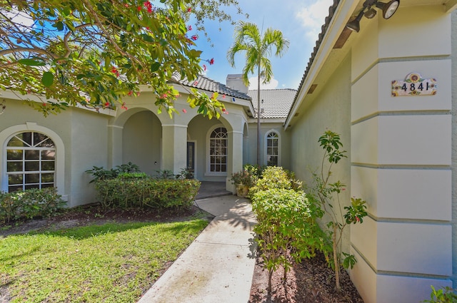 4841 Glenn Pine Ln, Boynton Beach, FL 33436 - doorway to property featuring stucco siding and a yard