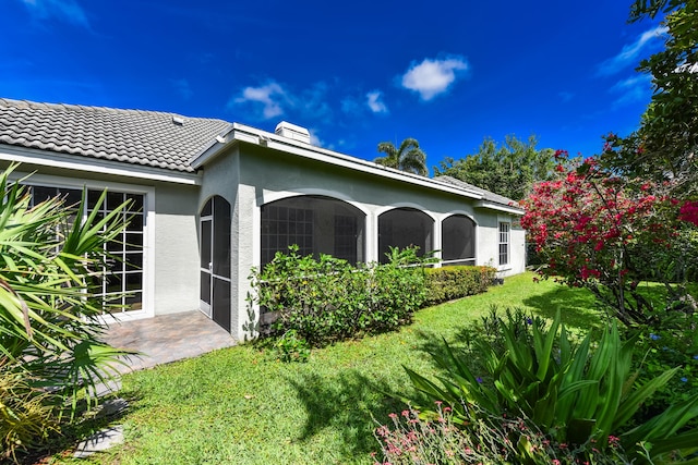 4841 Glenn Pine Ln, Boynton Beach, FL 33436 - view of side of property with stucco siding, a lawn, and a tile roof