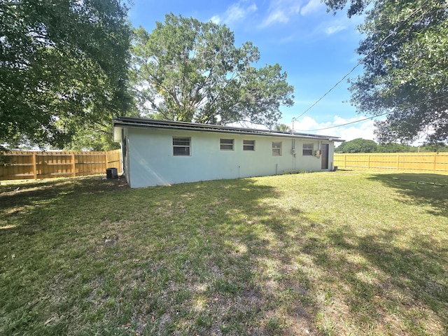 back of property featuring stucco siding and central AC unit