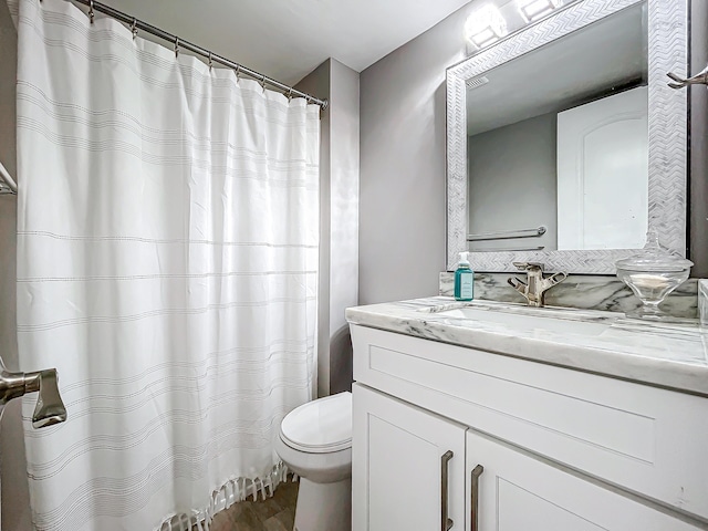 full bath featuring toilet, vanity, wood finished floors, and a shower with curtain