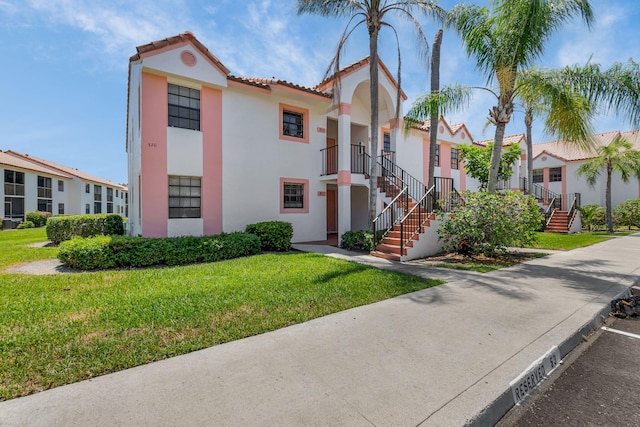 320 Norwood Ter Unit N114, Boca Raton, FL 33431 - view of front of home featuring stairway, stucco siding, and a front yard