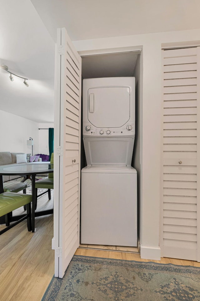 320 Norwood Ter Unit N114, Boca Raton, FL 33431 - clothes washing area with stacked washer and clothes dryer and light wood-style floors