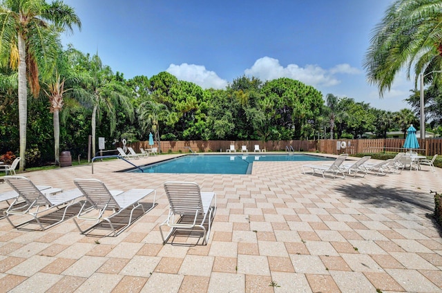 320 Norwood Ter Unit N114, Boca Raton, FL 33431 - community pool featuring fence, a patio area, and view of scattered trees
