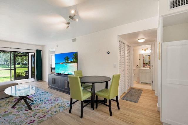 320 Norwood Ter Unit N114, Boca Raton, FL 33431 - dining space with light wood-style floors and track lighting