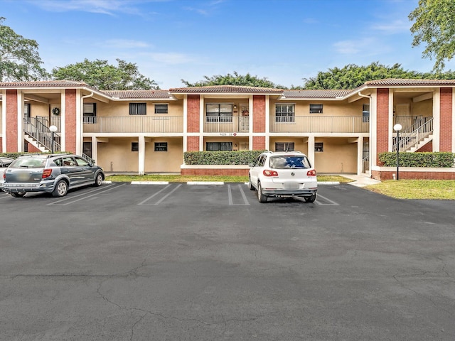 view of property featuring uncovered parking