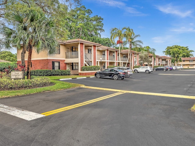 uncovered parking lot featuring a residential view