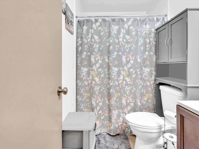 bathroom featuring toilet, a shower with curtain, and vanity