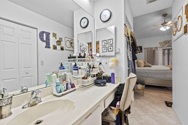 3646 English D Rd Unit D, Lake Worth, FL 33467 - ensuite bathroom featuring a textured ceiling, tile patterned flooring, a ceiling fan, and vanity