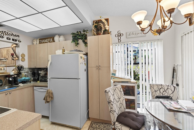 3646 English D Rd Unit D, Lake Worth, FL 33467 - kitchen with white appliances, decorative backsplash, light brown cabinets, and a chandelier