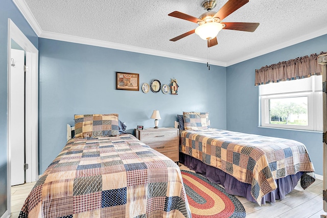 bedroom featuring a textured ceiling, ornamental molding, wood finished floors, and a ceiling fan