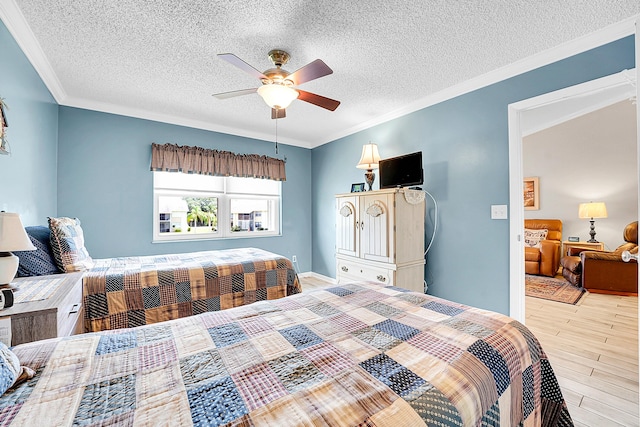 bedroom featuring wood finished floors, ornamental molding, a textured ceiling, and a ceiling fan