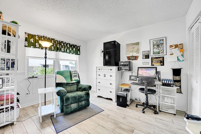 office space with a textured ceiling and wood finished floors