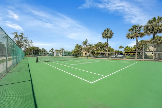 view of tennis court featuring fence