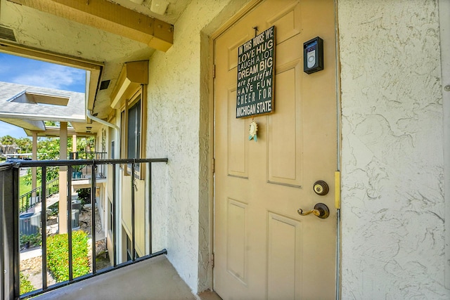 entrance to property with stucco siding
